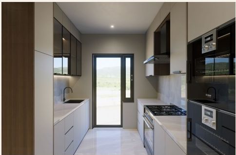 Fitted modular kitchen with built-in appliances and a hill-facing window