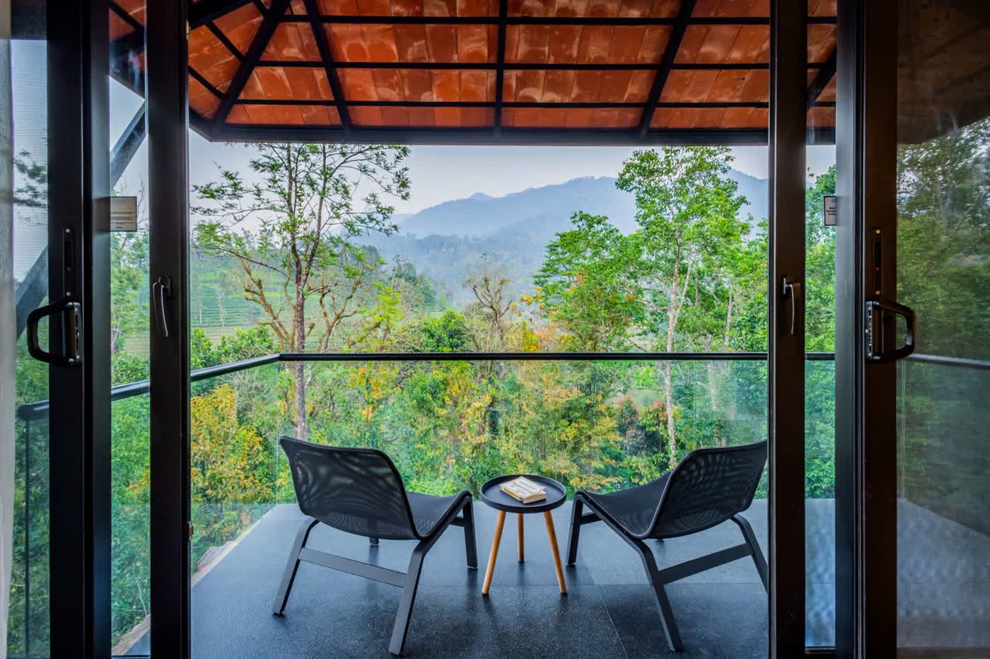 Real balcony view over forested Himalayan slopes